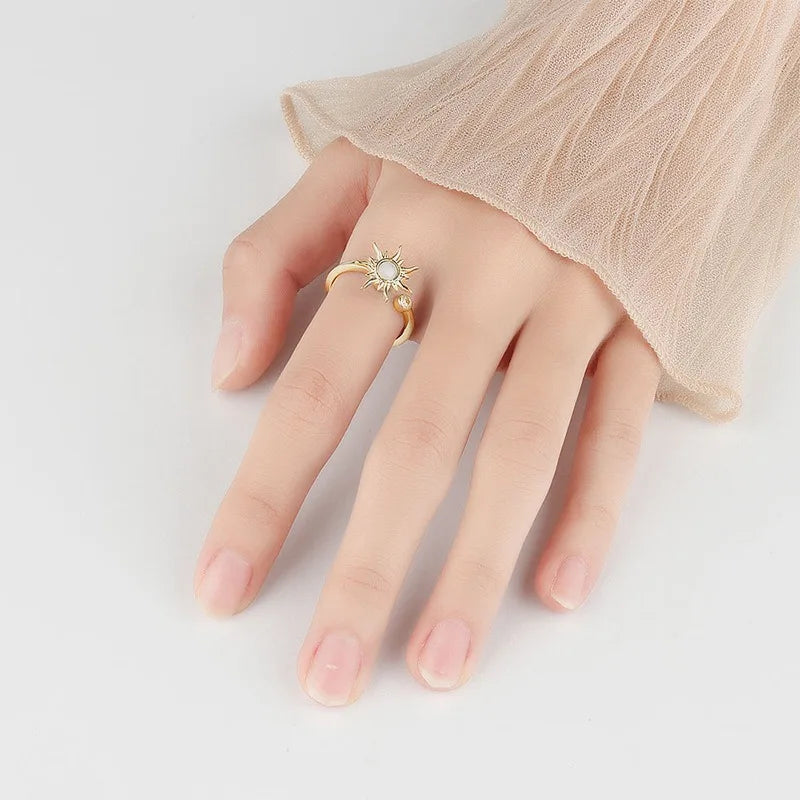 Model Wearing Gold Sterling Silver Sun Spinner Ring | Elegant Sunburst Detail, Demonstrating Soothing Spinning Action for Stress Relief